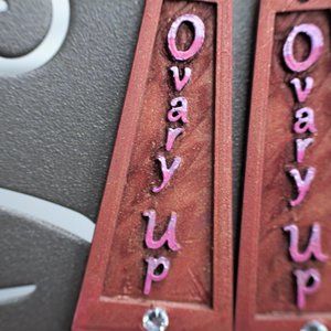 Ovary up earrings up, Magicians red charms, syfy